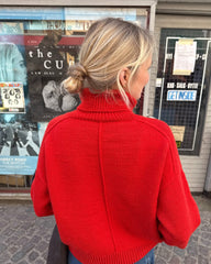 Kvinde med rød Scarlet Sweater set fra ryggen