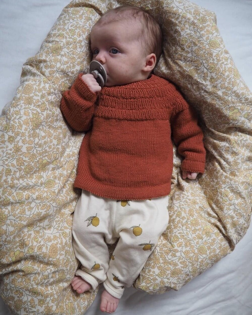 Barn iført rød Ankers Bluse