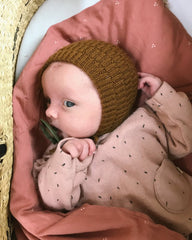 Baby iført brun Ankers Kyse