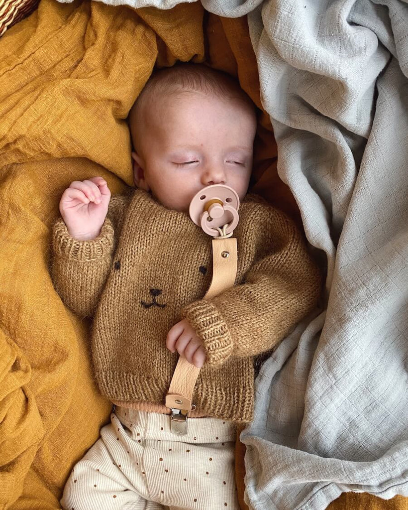 Baby iført lysebrun Bamsesweater