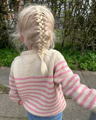 Barn iført hvid og lyserød Lyon Sweater Junior