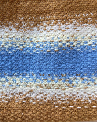 Struktur på Technicolor Purse i blå og brunlige nuancer