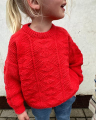 Barn iført rød Esther Sweater Junior