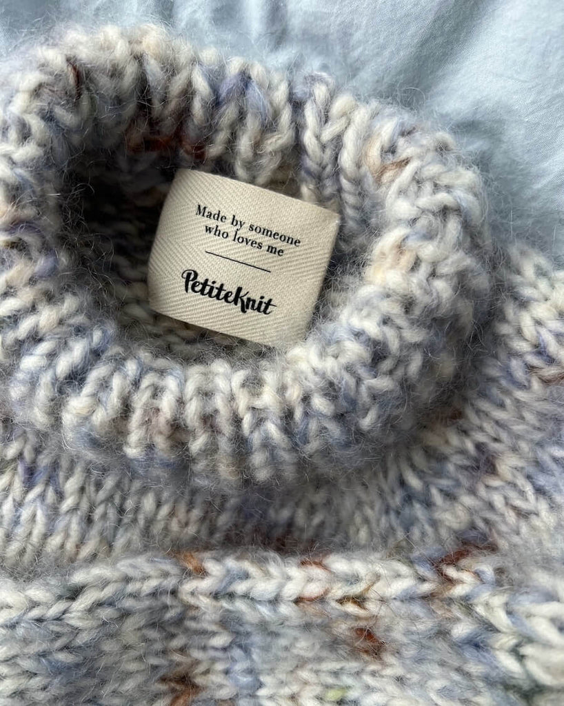tekstillabel med teksten "Made by someone who loves me" i. nakken af marble sweater