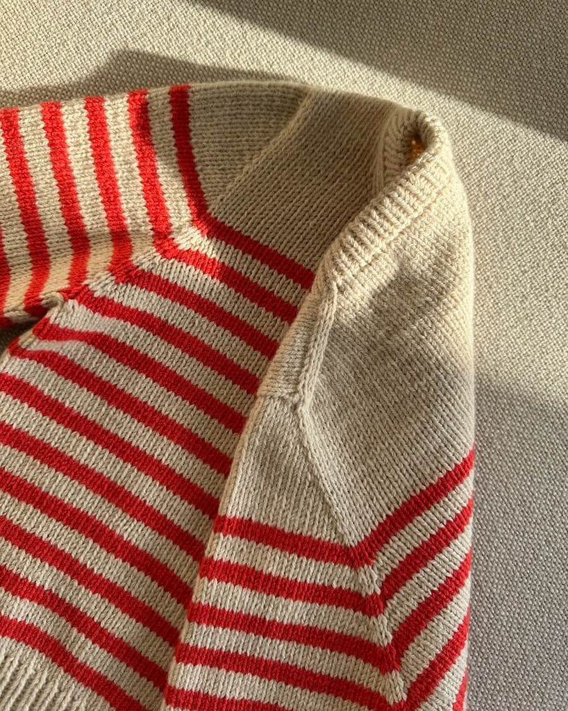 Detaljebillede af hvid og rød Lyon Sweater Junior 
